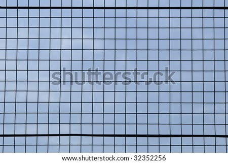 Closeup detail of metal grid against a blue sky background