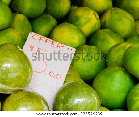 Group of fresh pomelo (Citrus maxima or Citrus grandis) fruits with price tag on display at the fruits stall at Bugis Village wet market, Singapore
