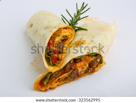 Wrap tortilla with meat, vegetables and spices