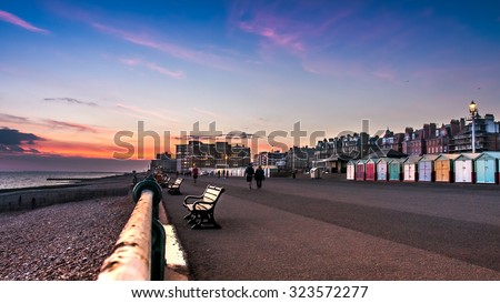 Beautiful sunset in Brighton, UK. Row of beach huts of Hove, vintage effect filter style  Royalty-Free Stock Photo #323572277