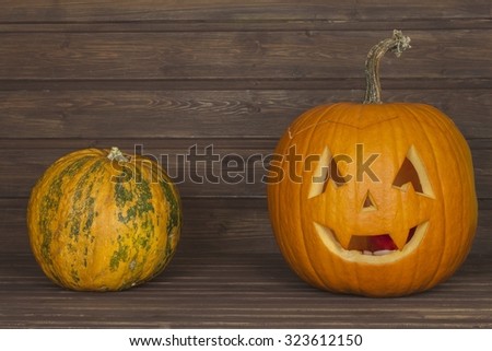 Halloween pumpkin head on wooden background. Preparing for Halloween. Head carved from a pumpkin on Halloween. Pumpkin tradition. Place for your text. Invitation for halloween. Scary Halloween pumpkin