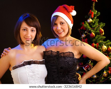 Two young girls in front of a Christmas tree