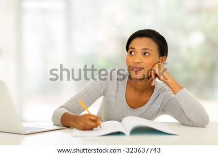 thoughtful young woman studying at home