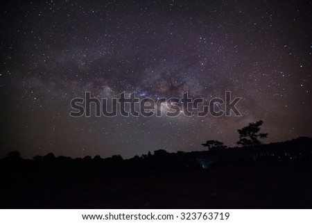 Milky Way and Silhouette of Tree at Phu Hin Rong Kla National Park,Phitsanulok Thailand. Long exposure photograph.with grain
