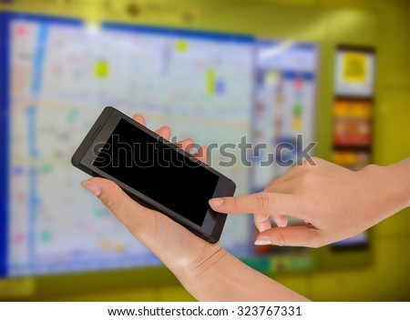 Businesswoman using her smart phone in working environment