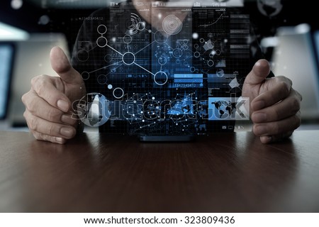 Businessman hand using mobile phone with digital layer effect as business strategy concept                  Royalty-Free Stock Photo #323809436