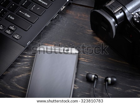 Wooden background with gadgets Royalty-Free Stock Photo #323810783