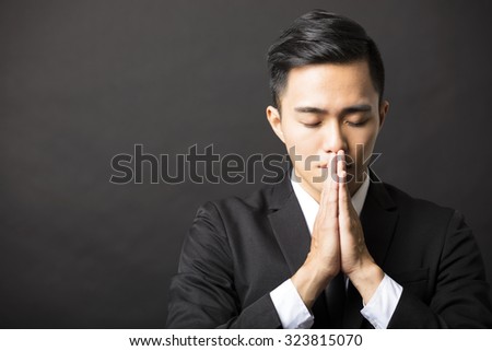 young business man with pray gesture