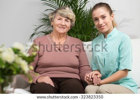 Nurse caring about elder woman in nursing home