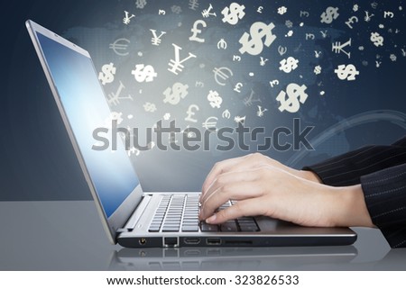 Image of businesswoman hands working on the laptop computer with currency symbols. Making money online concept