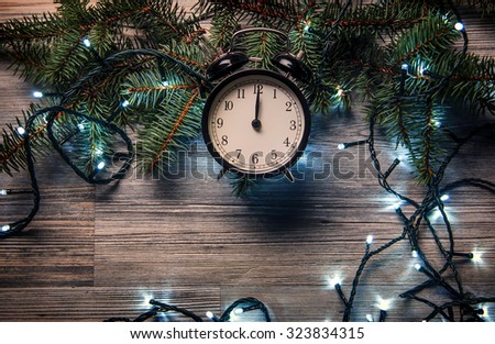 Christmas background. Alarm clock and christmas lights