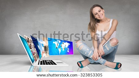 Laptop with many screens stand on the floor and woman beside.Elements of this image furnished by NASA
