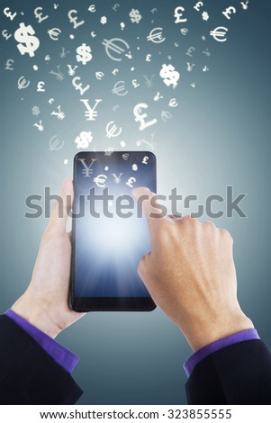 Image of hands holding smartphone with currency symbols flying away. Making money concept