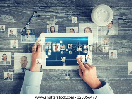 business, people, international communication, headhunting and technology concept - close up of hands pointing finger to tablet pc computer screen with world map and internet contacts network on table Royalty-Free Stock Photo #323856479