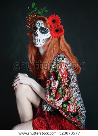 photo portrait of red haired girl with red flowers in her hair sitting makeup Los Muertos