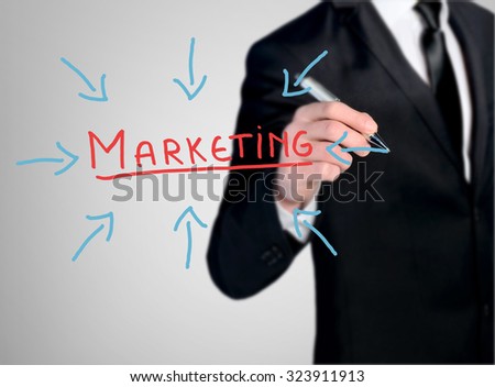 Business man close-up write Marketing word