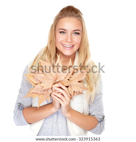 Portrait of beautiful blond girl with dry maple leaves isolated on white background, enjoying autumn season