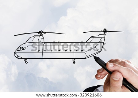 Person hand drawing helicopter model ob sky background