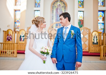 wedding couple at church looking and smile each other