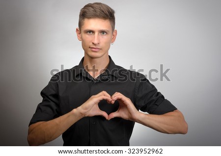 Young man making heart sign