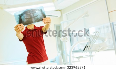 picture of female doctor or dentist looking at x-ray
