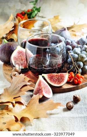 Red wine, figs, and grapes, autumn decoration for Thanksgiving, selective focus