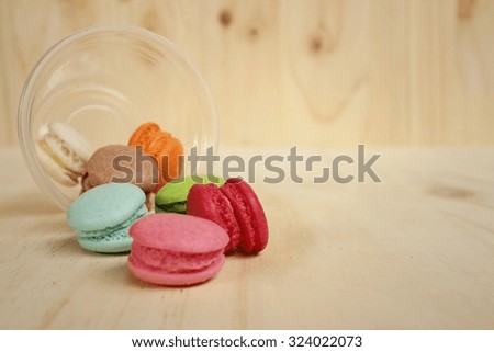 Colorful of macarons on background of brown wood.