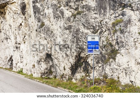 Routier sign Falzarego pass in Italy Dolomites mountains.