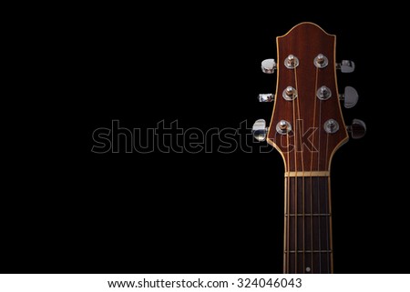 Guitar headstock on black background Royalty-Free Stock Photo #324046043