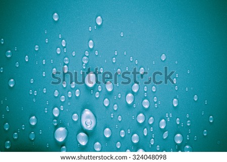 Drops of water on a color background. Blue. Shallow depth of field. Selective focus.