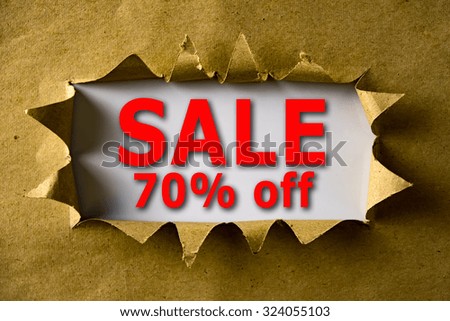 Torn brown paper with SALE 70% OFF words