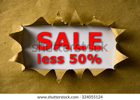 Torn brown paper with SALE LESS 50% words