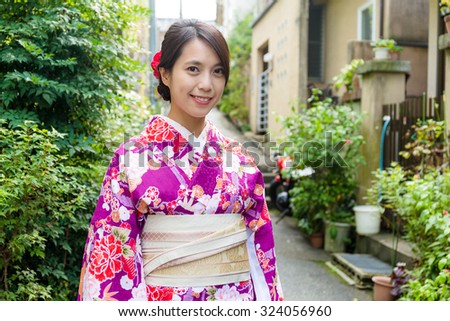 Young woman with kimono dress on street