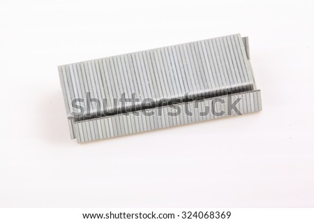 Stack of metal staples on a white background.