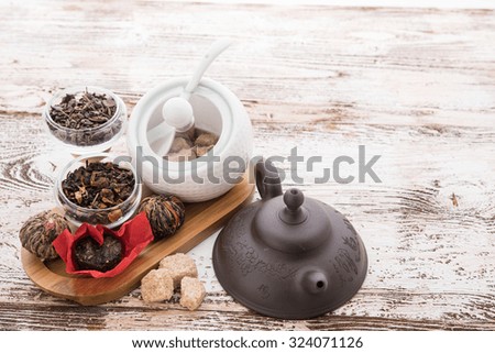 Tea cups with teapot on old wooden table