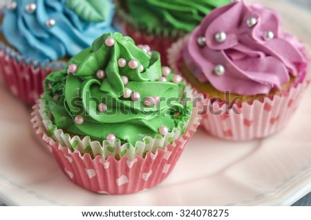  Cupcakes decorated with butter cream in various colors