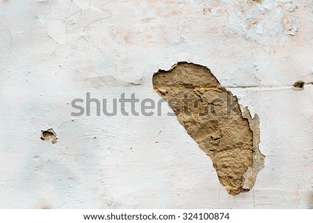 Hole in plaster of white wall