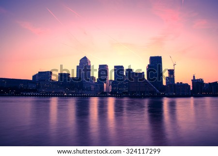 Canary Wharf modern buildings in London on river Thames, filtered image