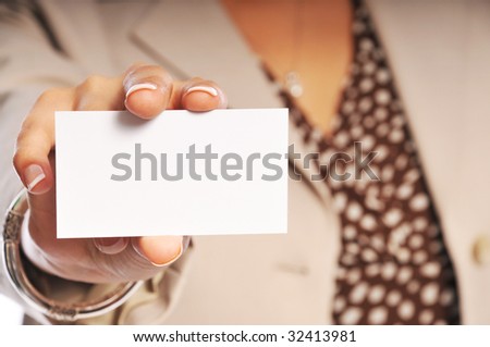 woman showing her business card with focus on the card.