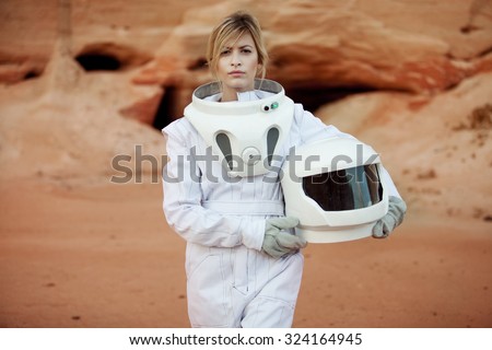 futuristic astronaut without a helmet on another planet, image with the effect of toning Royalty-Free Stock Photo #324164945
