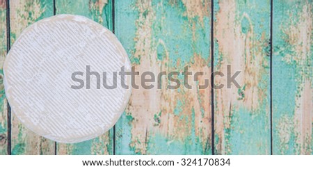 Round blue cheese over wooden background