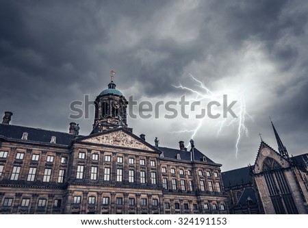 Lightning strike on a cloudy sky over the ancient building. Toned photo.