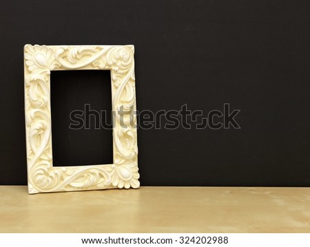 A photo frame on a wooden shelf