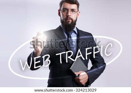 businessman writing Web Traffic with marker on visual screen.Business, technology, internet concept. 