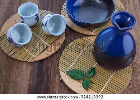 Japanese Sake drinking set on old wood texture background