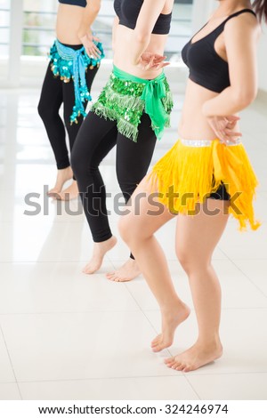 Legs of women performing traditional Arabic dance Royalty-Free Stock Photo #324246974