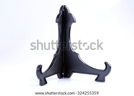 Black plastic Book Display Stand isolated on white background.