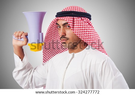 Arab man shouting through loudspeaker Royalty-Free Stock Photo #324277772