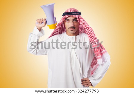 Arab man shouting through loudspeaker Royalty-Free Stock Photo #324277793