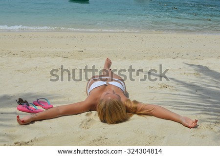 Suntanning on beach in Thailand